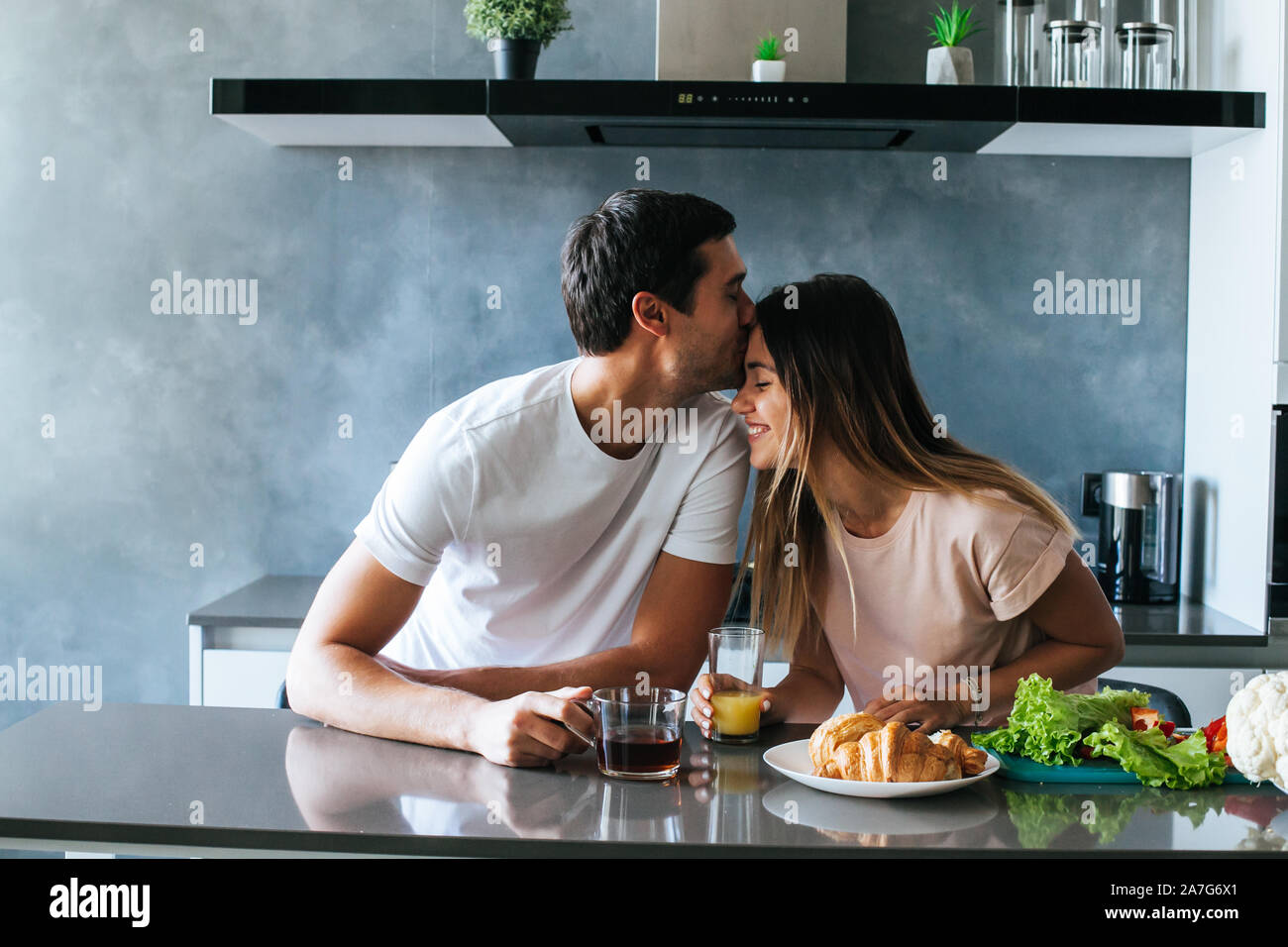 Photo of young couple starting the day together with coffee in the kitchen Stock Photo