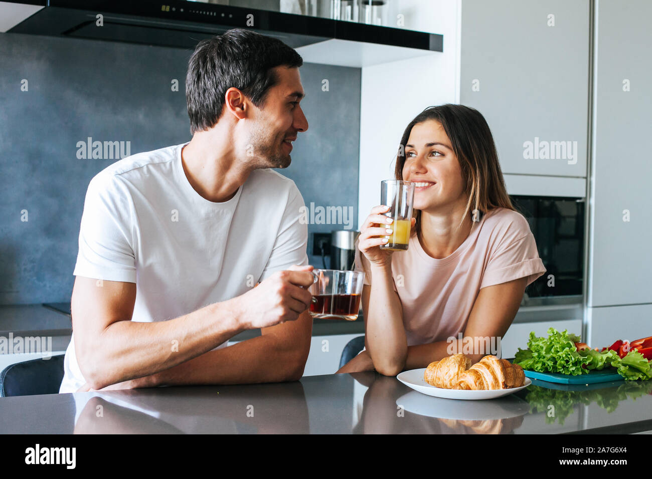 Photo of young couple starting the day together with coffee in the kitchen Stock Photo