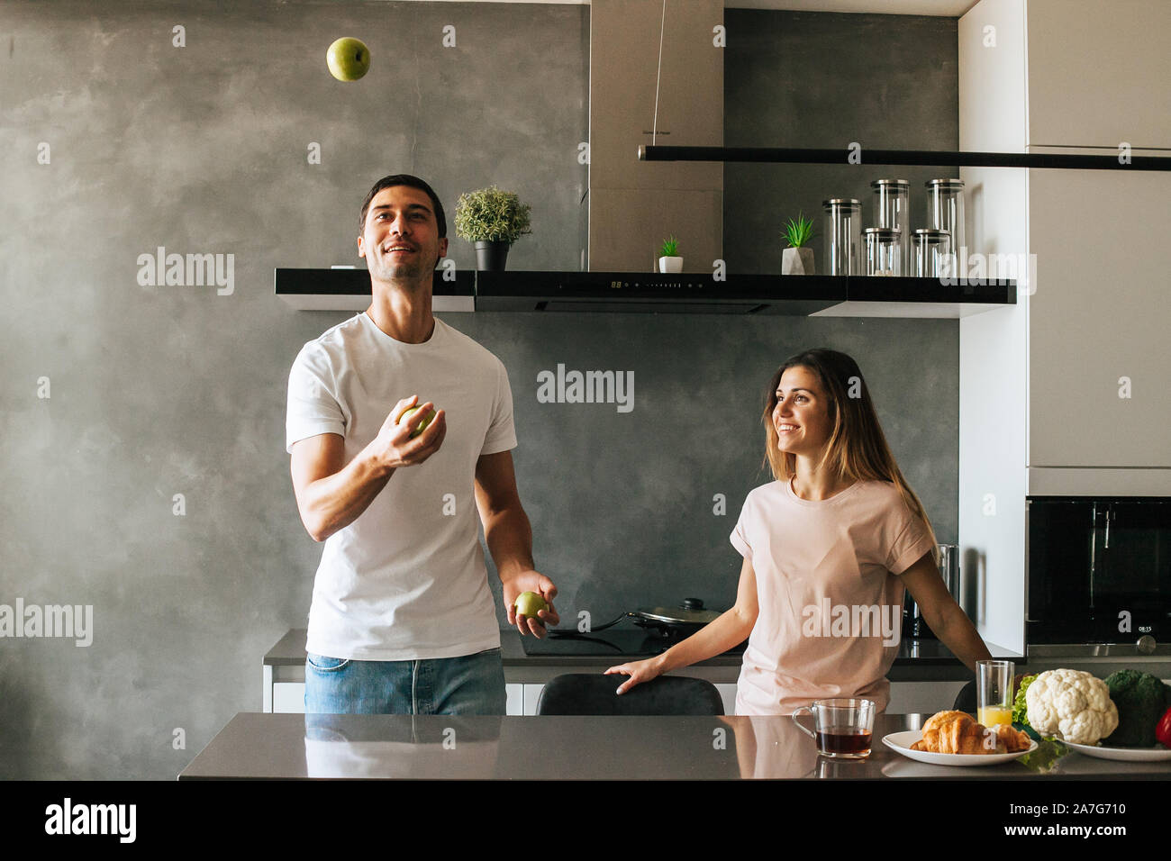 young couple cooking a vegetarian breakfast in the morning in a bright kitchen Stock Photo