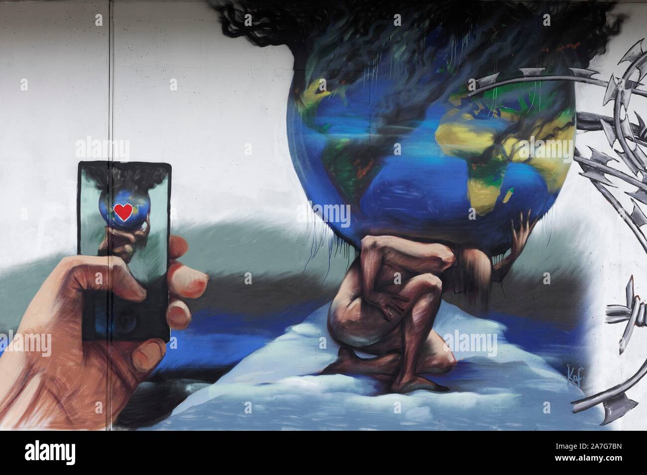 Mythological figure Atlas carries the globe, earth threatened by climate change, symbolic mural, street art, 40 degrees Urban Art Festival 2019 Stock Photo