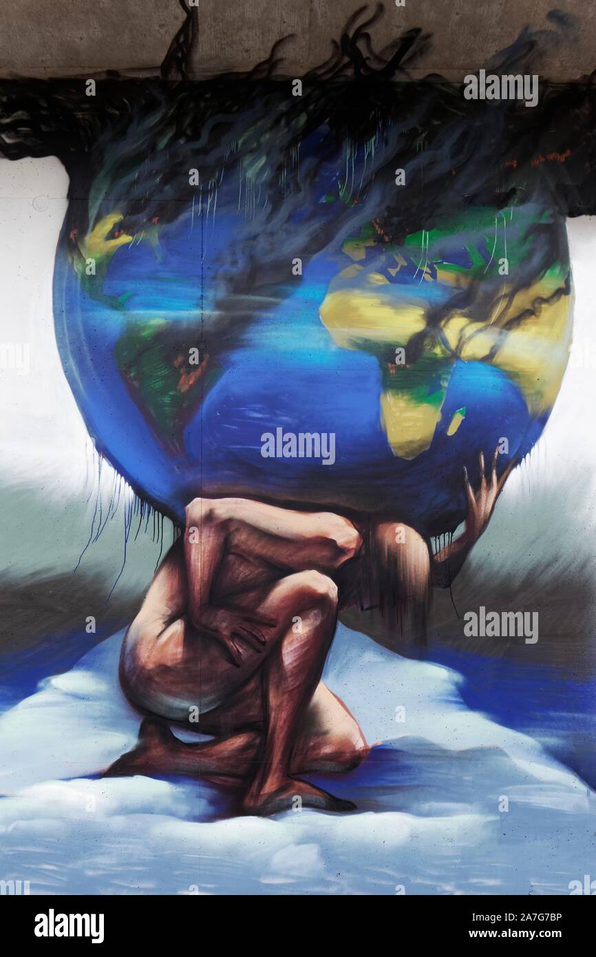 Mythological figure Atlas carries the globe, earth threatened by climate change, symbolic mural, street art, 40 degrees Urban Art Festival 2019 Stock Photo