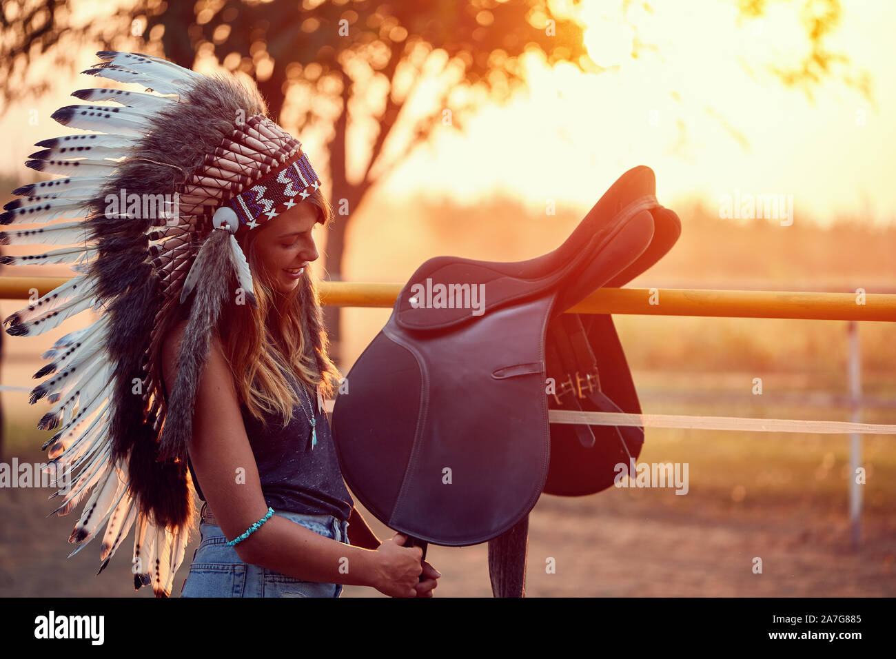 Smiling American Indian girl and horse at the sunset. Stock Photo