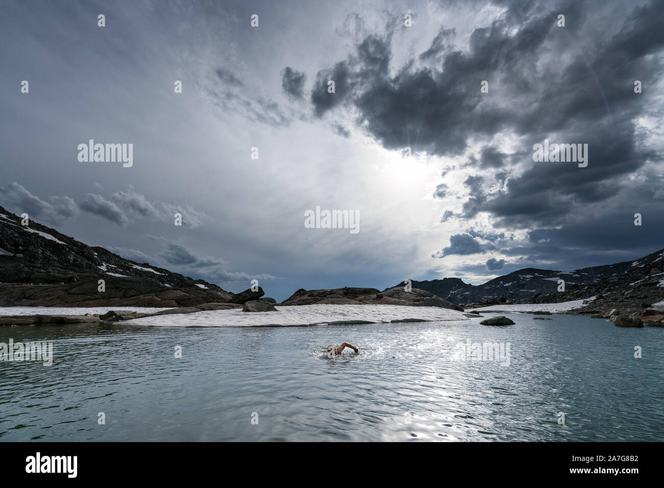 Hiking on the Wind River High Route and having an evening swim after a long day, Wyoming, USA Stock Photo