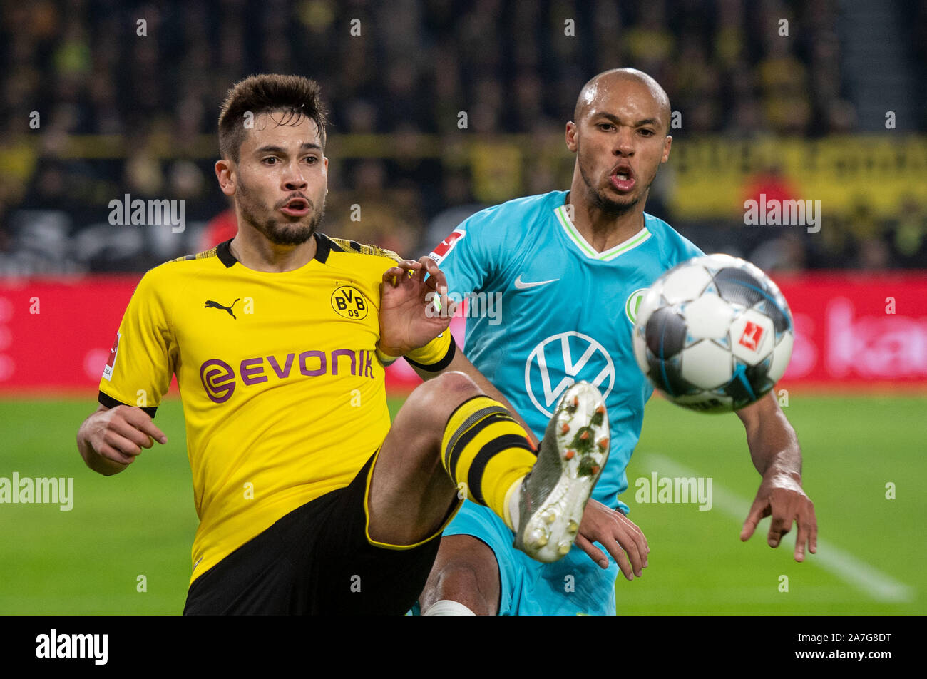 Dortmund, Germany. 02nd Nov, 2019. Soccer: Bundesliga, Borussia Dortmund - VfL Wolfsburg, 10th matchday at Signal Iduna Park. Dortmund's Raphael Guerreiro (l) and Marcel Tisserand von Wolfsburg try to get the ball. Credit: Bernd Thissen/dpa - IMPORTANT NOTE: In accordance with the requirements of the DFL Deutsche Fußball Liga or the DFB Deutscher Fußball-Bund, it is prohibited to use or have used photographs taken in the stadium and/or the match in the form of sequence images and/or video-like photo sequences./dpa/Alamy Live News Stock Photo
