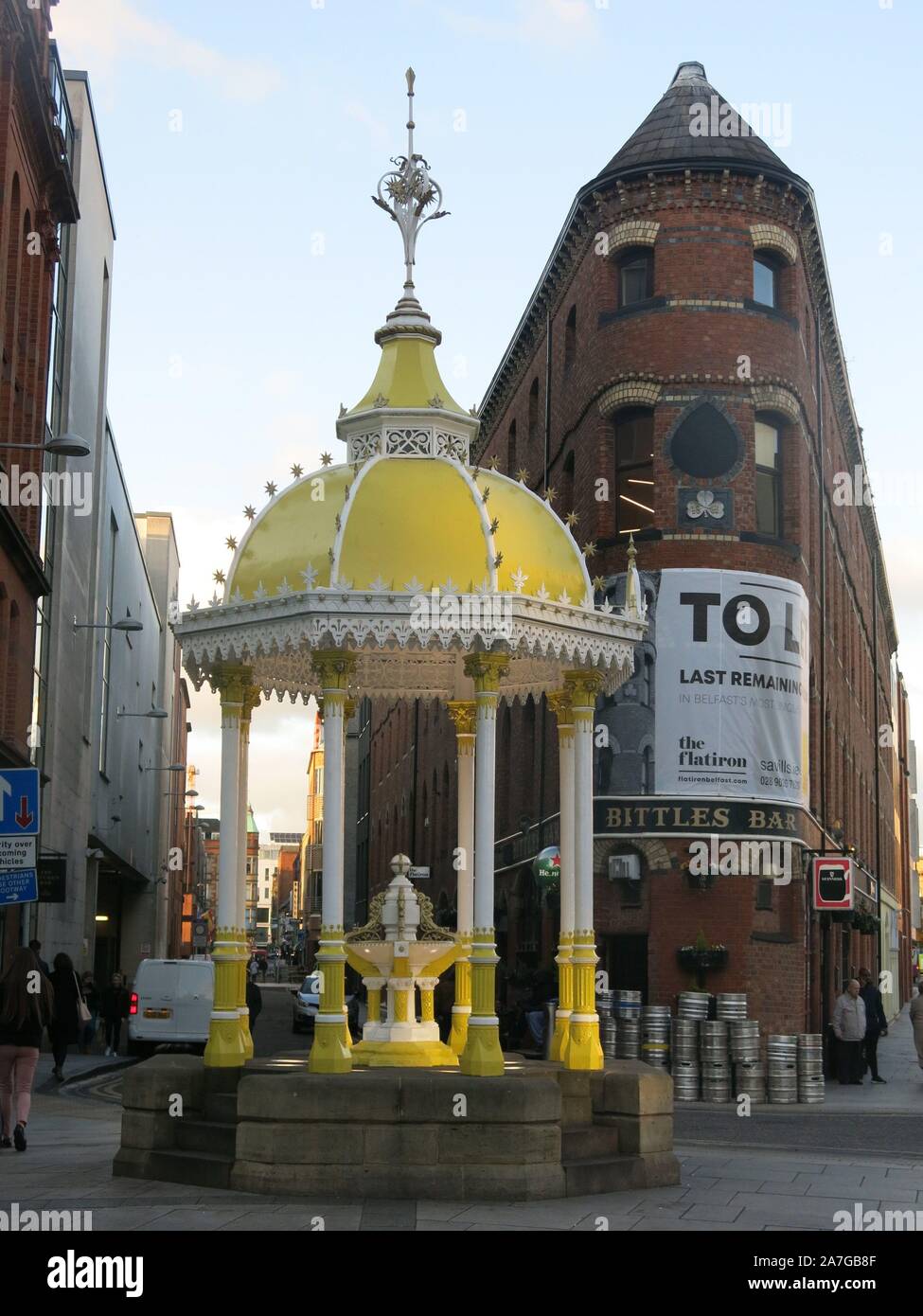 View of the ornate yellow fountain outside the flatiron building at