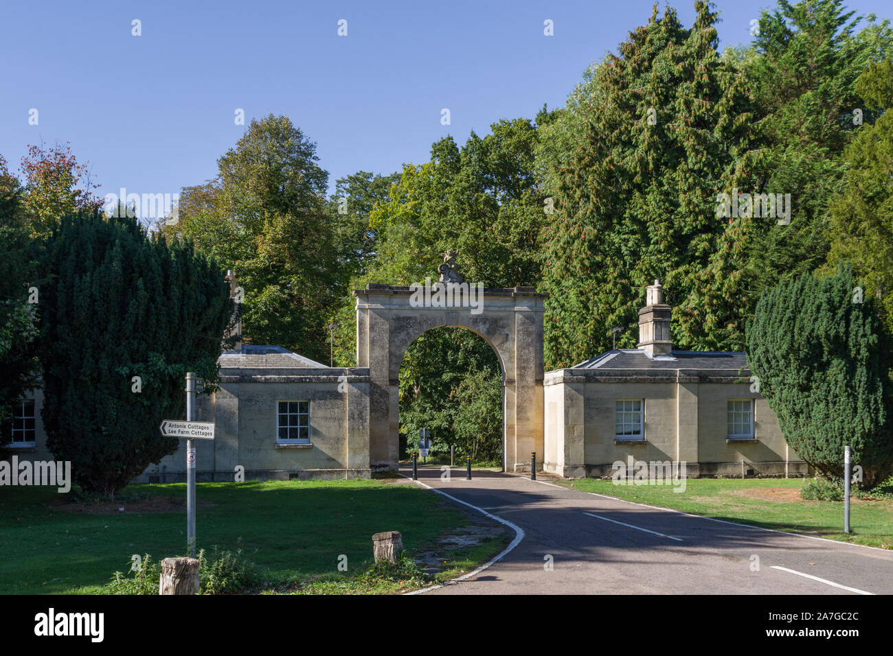 Pair of 18th century gatehouses joined by an arch at the entrance to Colworth House, Sharnbrook, Bedfordshire, UK Stock Photo