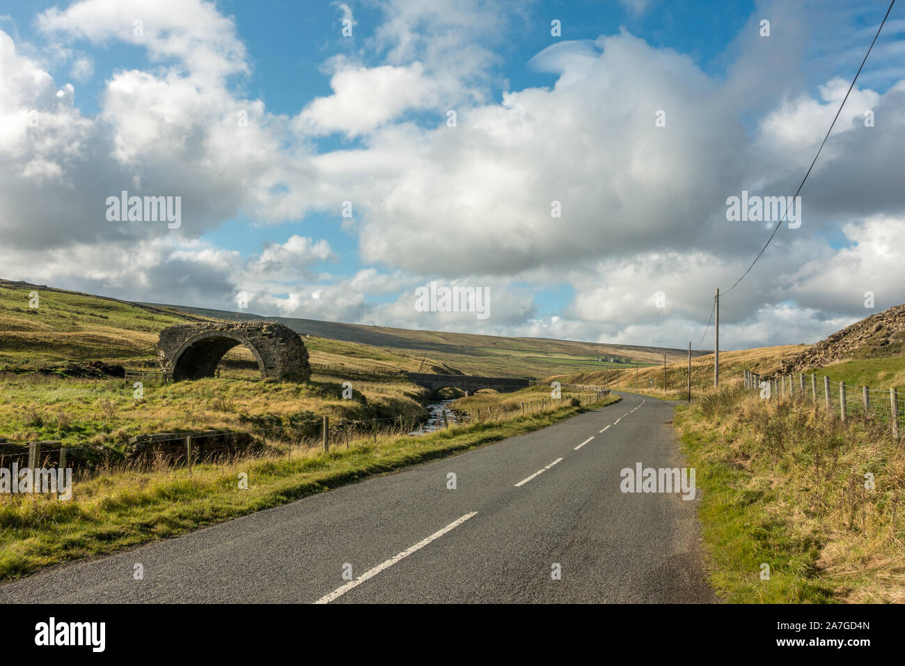 Remaining arch of the lead smelt mill flue viaduct bridge next to the road, Rookhope, above Weardale, County Durham, England, UK Stock Photo
