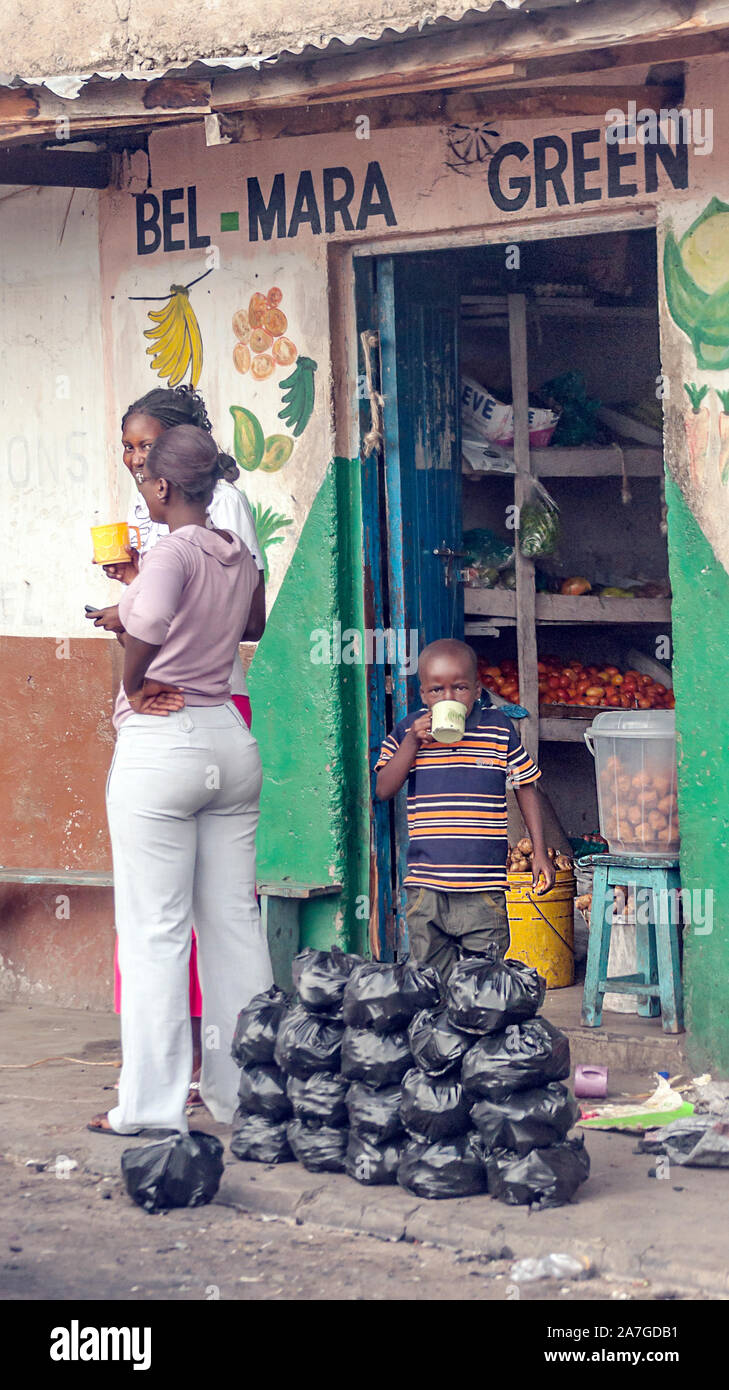 NAIROBI, KENYA - MAY 2014. Laughing african woman with colorful clothes outdoors at typical traditional market of Kenya Stock Photo