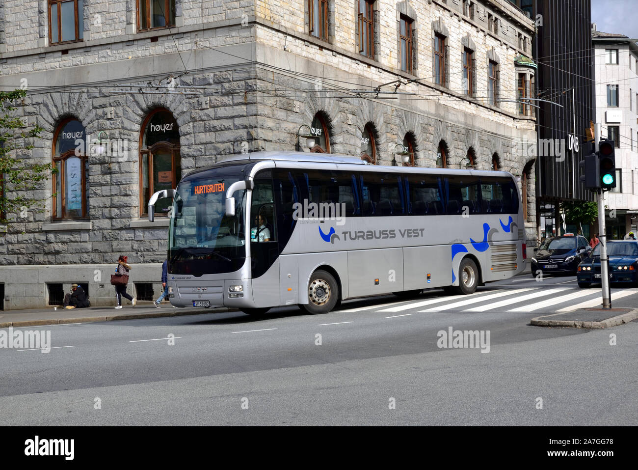 A Tide Buss MAN Lion's Coach, operated under the Turbuss Vest brand, is seen turning from Torgallmenningen into Strandgaten, Bergen, on a Hurtigruten Stock Photo