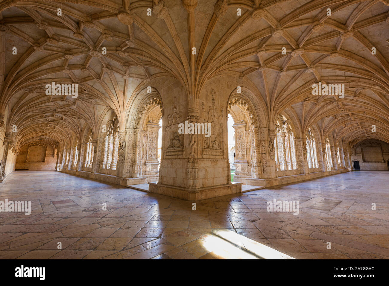 Ornamental and empty cloister at the historic Manueline style Mosteiro dos Jeronimos (Jeronimos Monastery) in Belem, Lisbon, Portugal, on a sunny day. Stock Photo