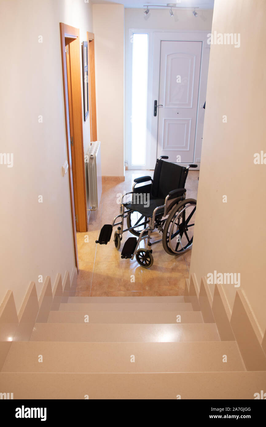 A wheelchair in front of a staircase in a house. Disability concept Stock  Photo - Alamy, image size:866x1390