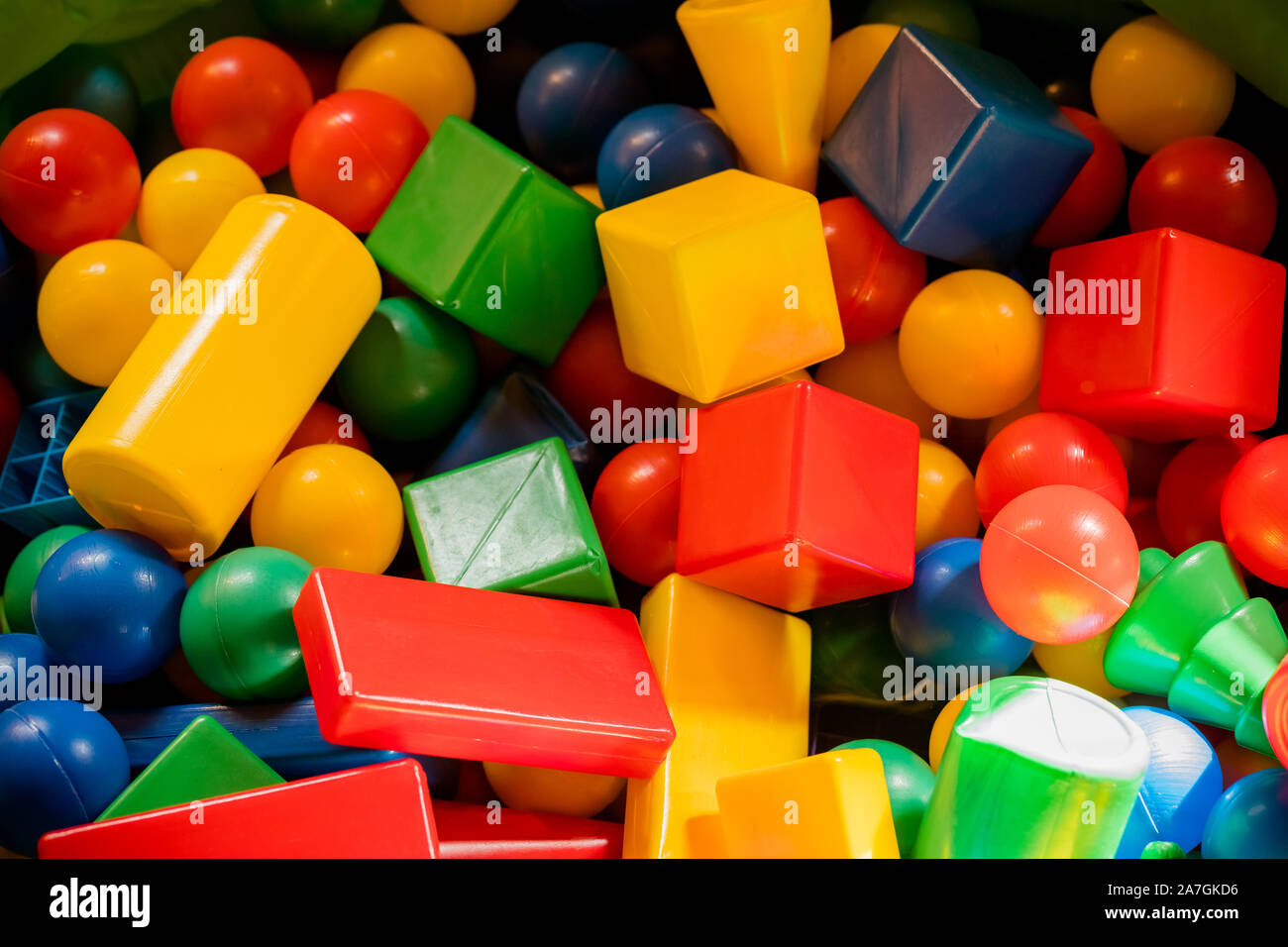 Multicolored plastic building blocks of the designer. Background of plastic colored details building blocks. Parts of bright small spare parts for toy Stock Photo