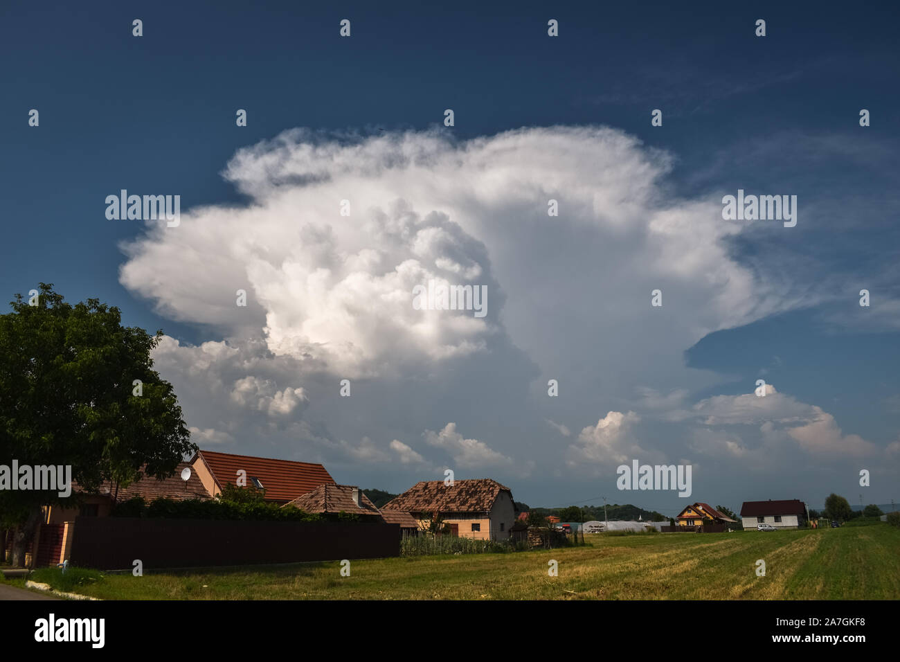 Classic example of a typical summer thunderstorm with updraft and anvil over the Carpathian mountains in Romania, eastern Europe Stock Photo