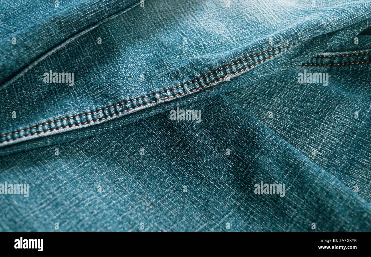 Folded turquoise blue jeans abstract background. Selective focus Stock ...