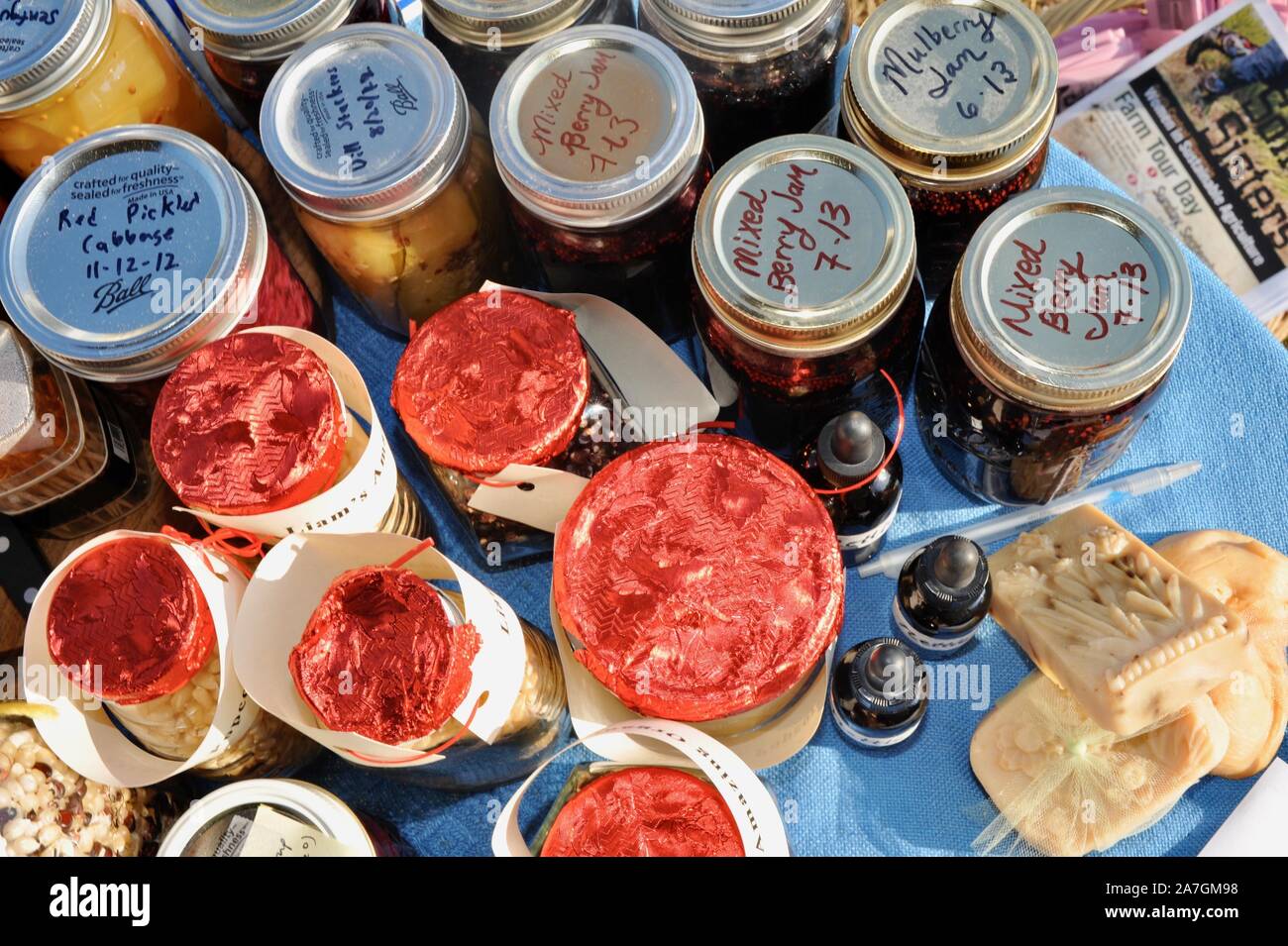 Various kinds of food, including canned items, freely exchanged at a community food swap held in the backyard of a participant's home, Wisconsin, USA Stock Photo