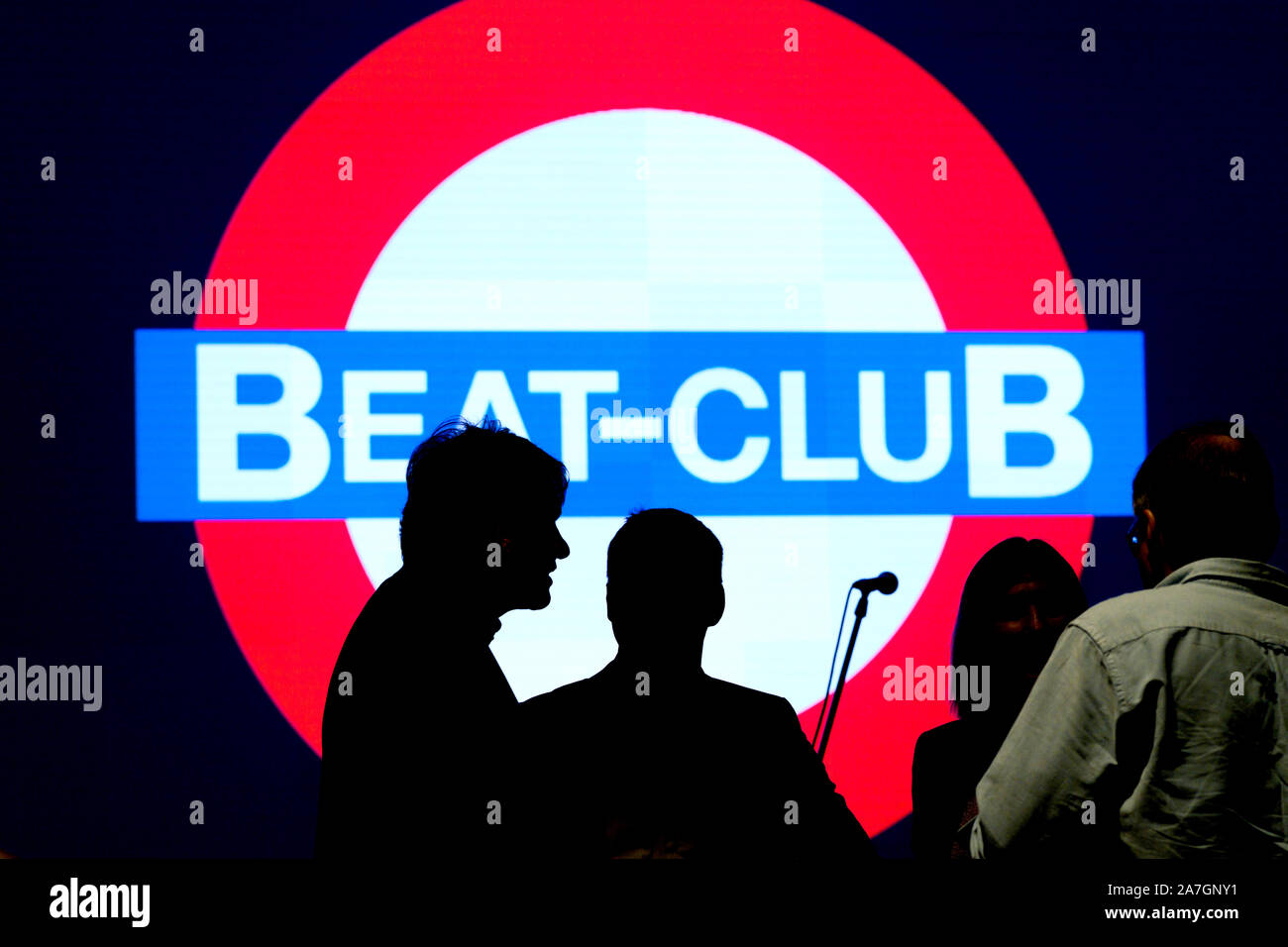 Bremen, Germany. 02nd Nov, 2019. Silhouettes can be seen in front of a  projected Beat Club logo in Radio Bremen's Funkhaus during the presentation  of the new Beat Club special issue stamp,