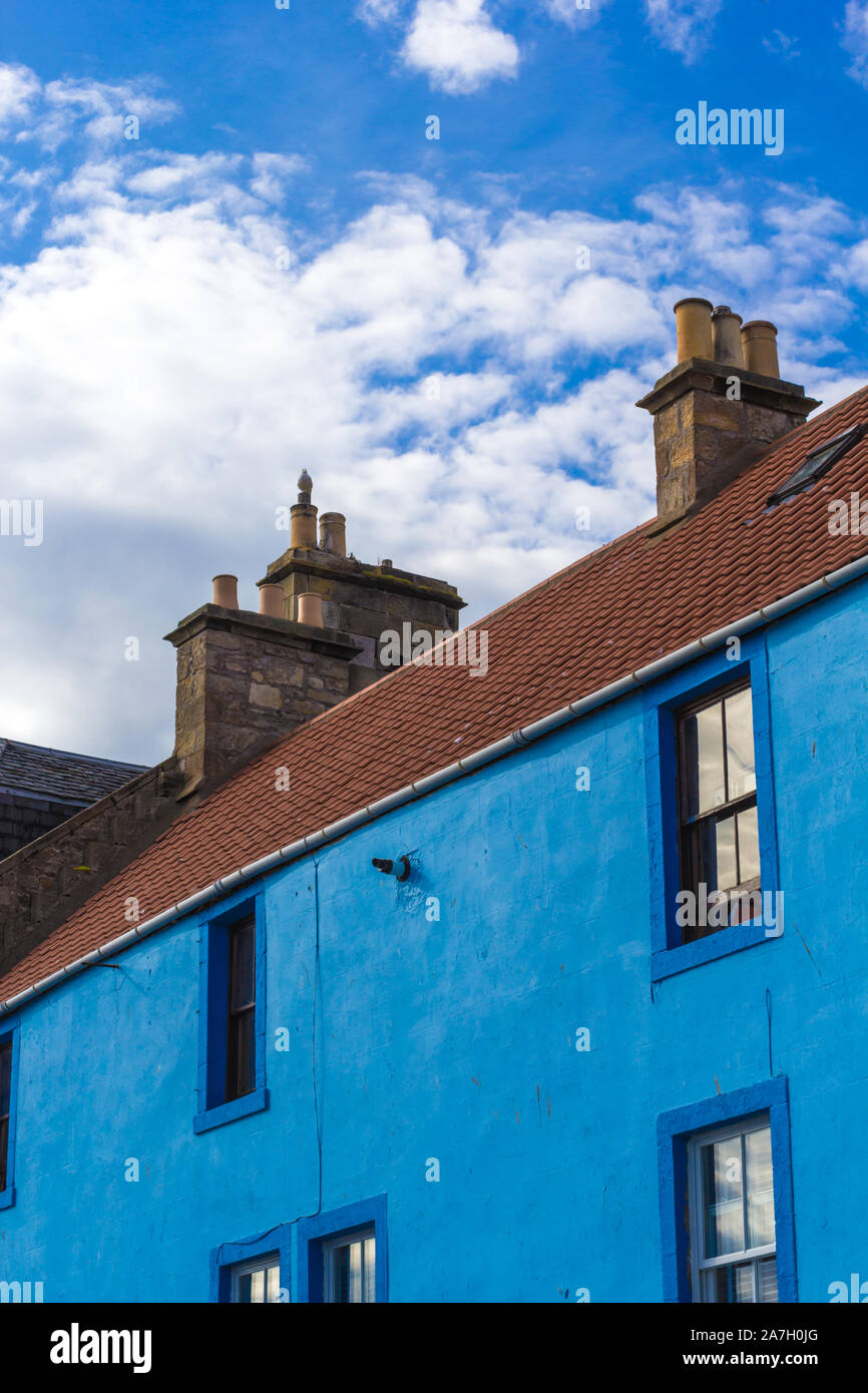 Old blue house and blue sky with white clouds Stock Photo - Alamy