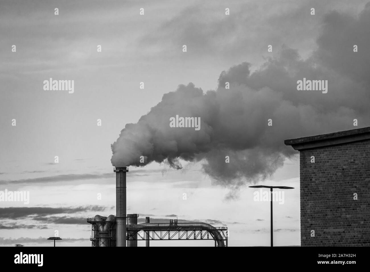 a lot of smoke and fumes are coming up from an industrial chimney Stock