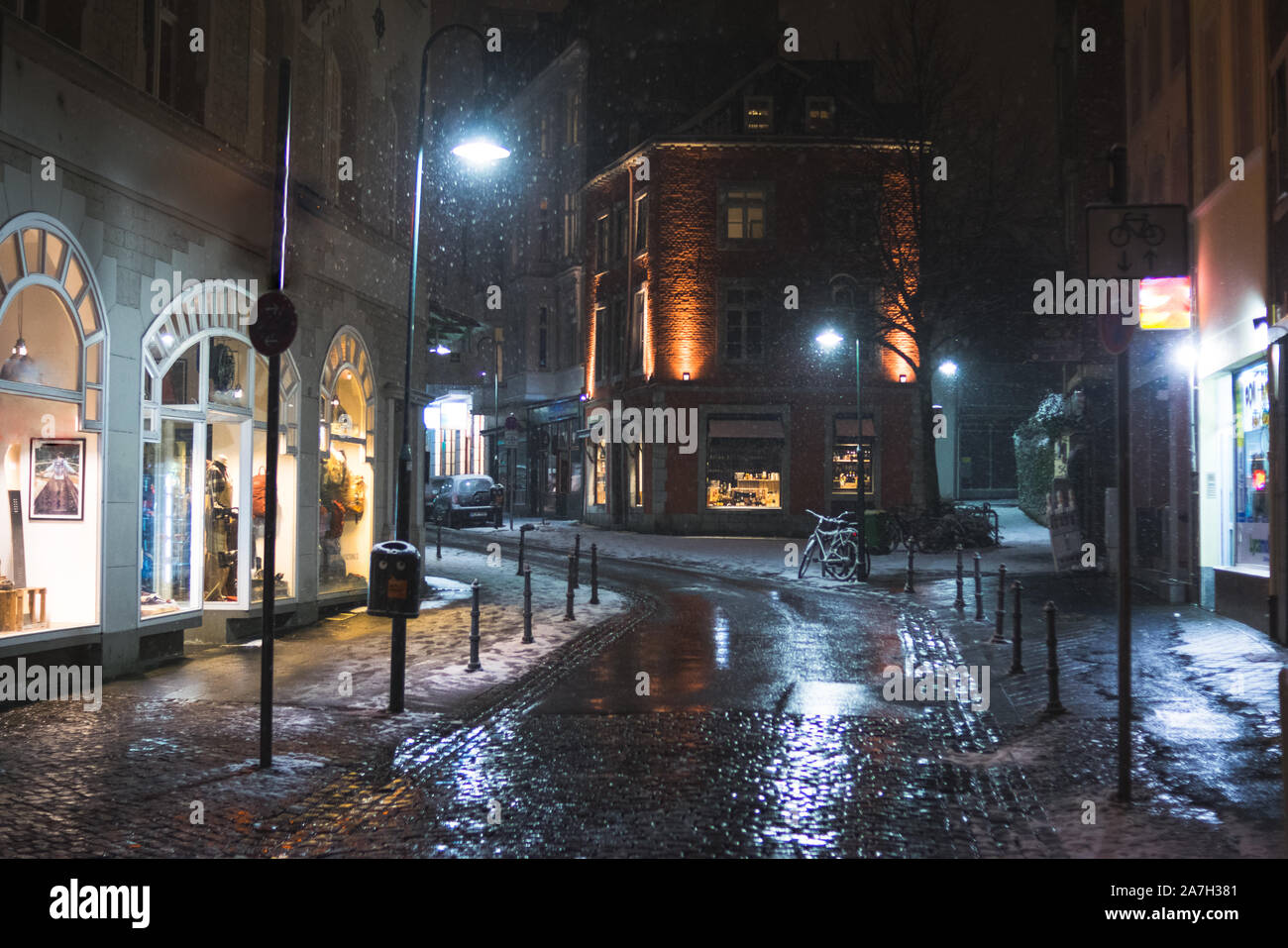 Snowy empty street at night in Aachen, Germany Stock Photo