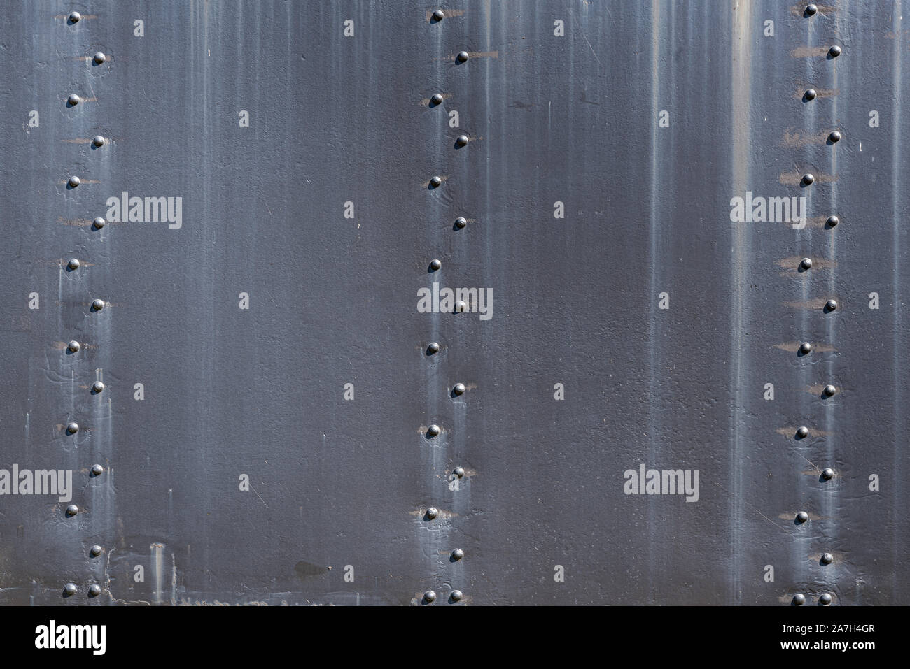 Old Rusty Black Steel Plates and Rivets Background Stock Photo