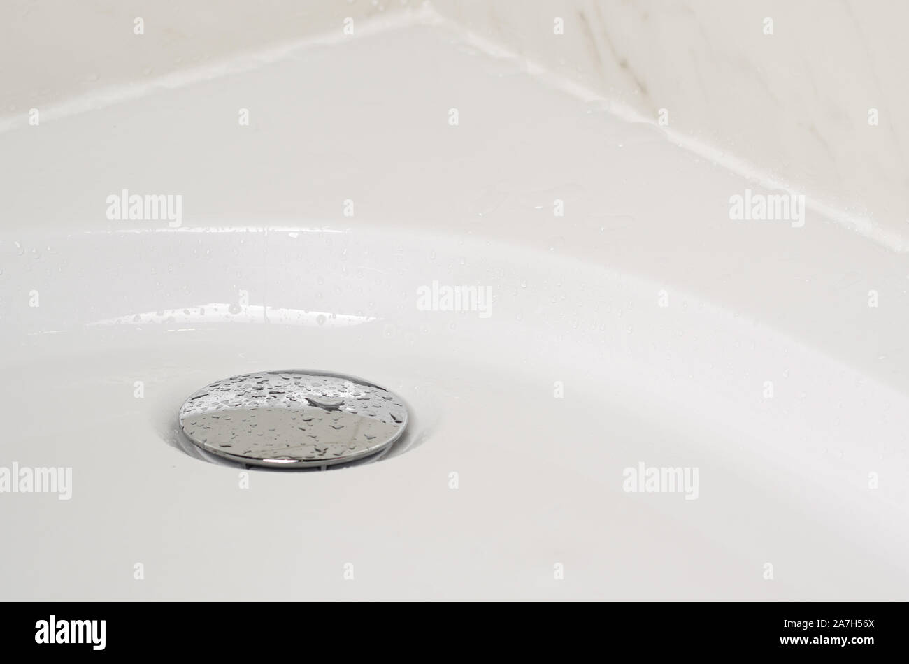 Shower tray and water tap or drain plug with drops of water. Fungus