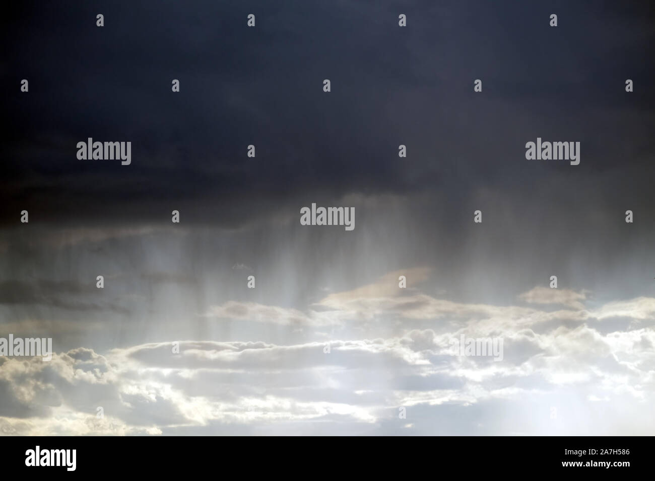 Natural landscape with bad weather with storm sky with many heavy deep dark rainy clouds and raining Stock Photo