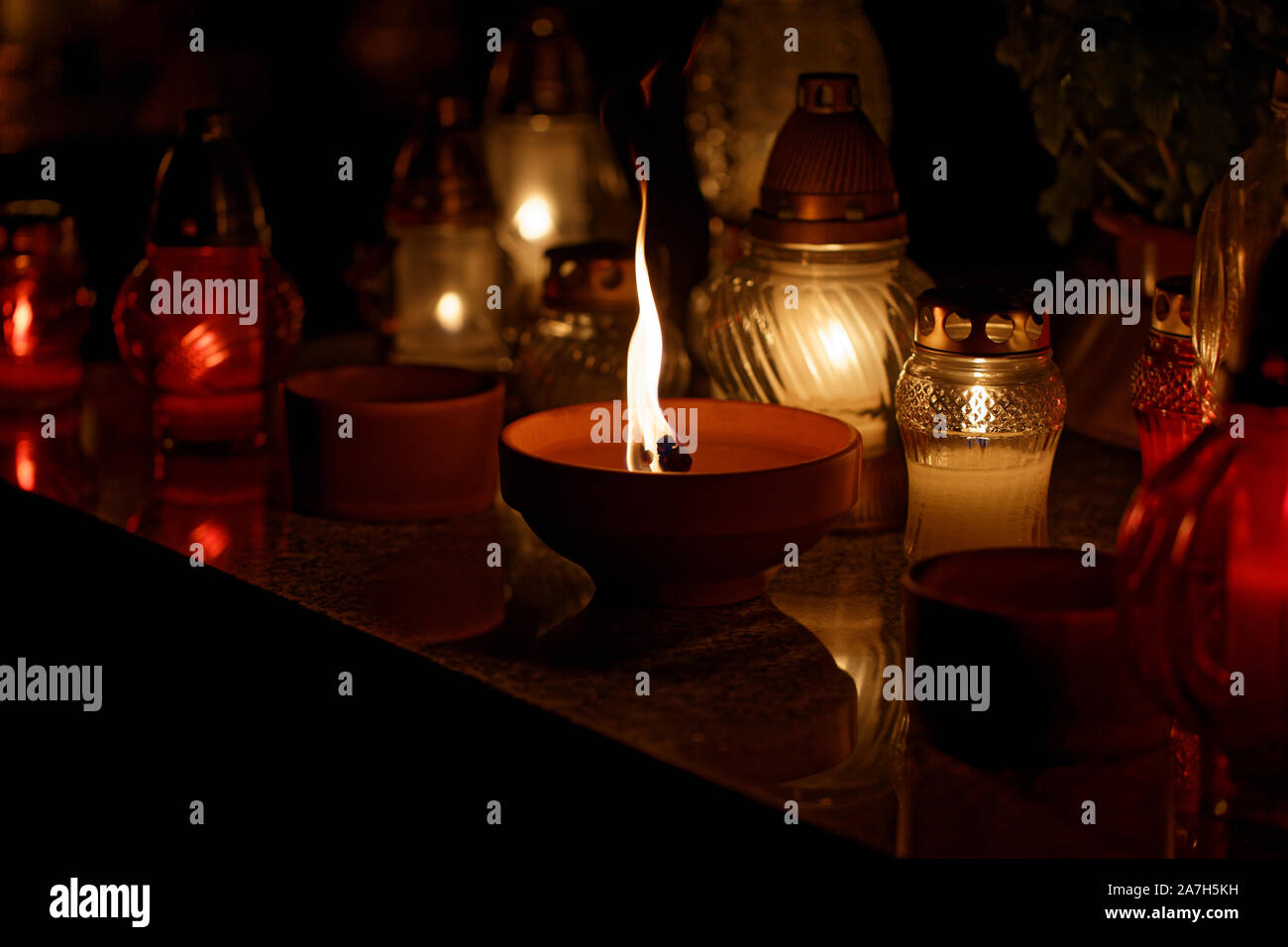 Candle burning at a Cemetery during All Saints Day close up Stock Photo