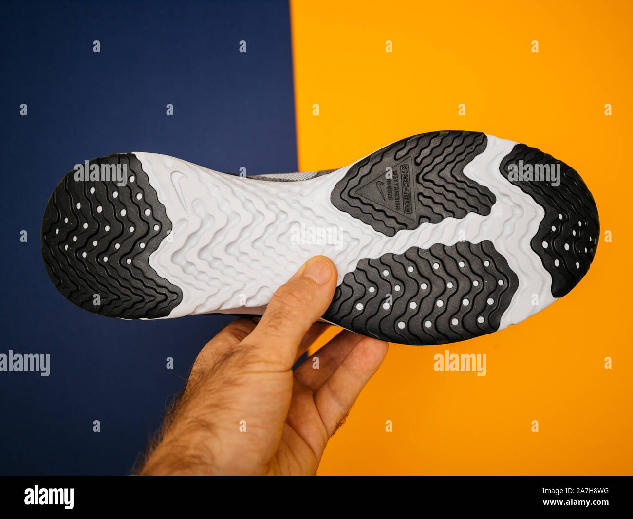 Paris, France - Oct 18, 2019: Man hand holding blue yellow background new  sport waterproof and windproof running shoe Nike Odyssey React Shield 2  insp Stock Photo - Alamy