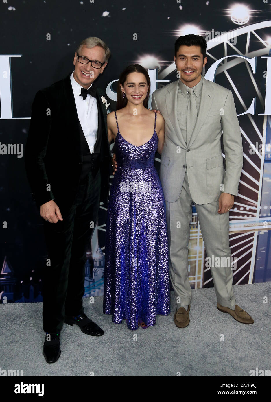 (L-R) Paul Feig, Emilia Clarke and Henry Golding attend the premiere of 'Last Christmas' at AMC Lincoln Square on October 29, 2019 in New York City. Stock Photo