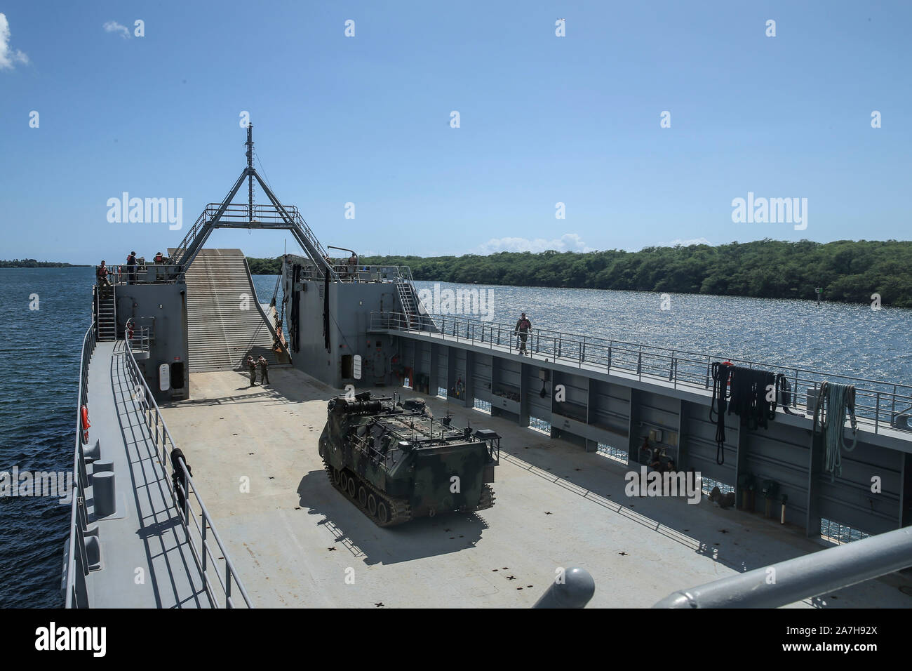 A U.S. Marine Corps AAV-P7/A1 Amphibious Assault Vehicle aboard U.S. Army logistics support vessel USAV CW3 Harold C. Clinger (LSV-2) waits to be transferred to the USS New Orleans (LPD-18) as part of an Army to Navy, ship-to-ship transfer of Marine Corps assets at Joint Base Pearl Harbor-Hickam, Hawaii, Oct. 24, 2019. The evolution further developed the services’ joint operational capabilities, interoperability and flexibility in the Indo-Pacific region. (U.S. Marine Corps photo by Lance Cpl. Nunez) Stock Photo