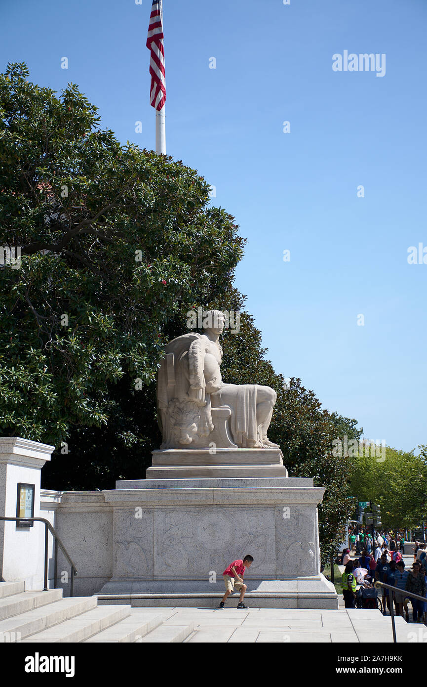 Young male near Heritage and Guardianship statue at National Archives in Washington DC Stock Photo