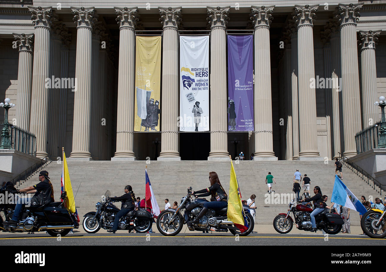 Motorcycle group riding Harley Davidson with South American flags in
