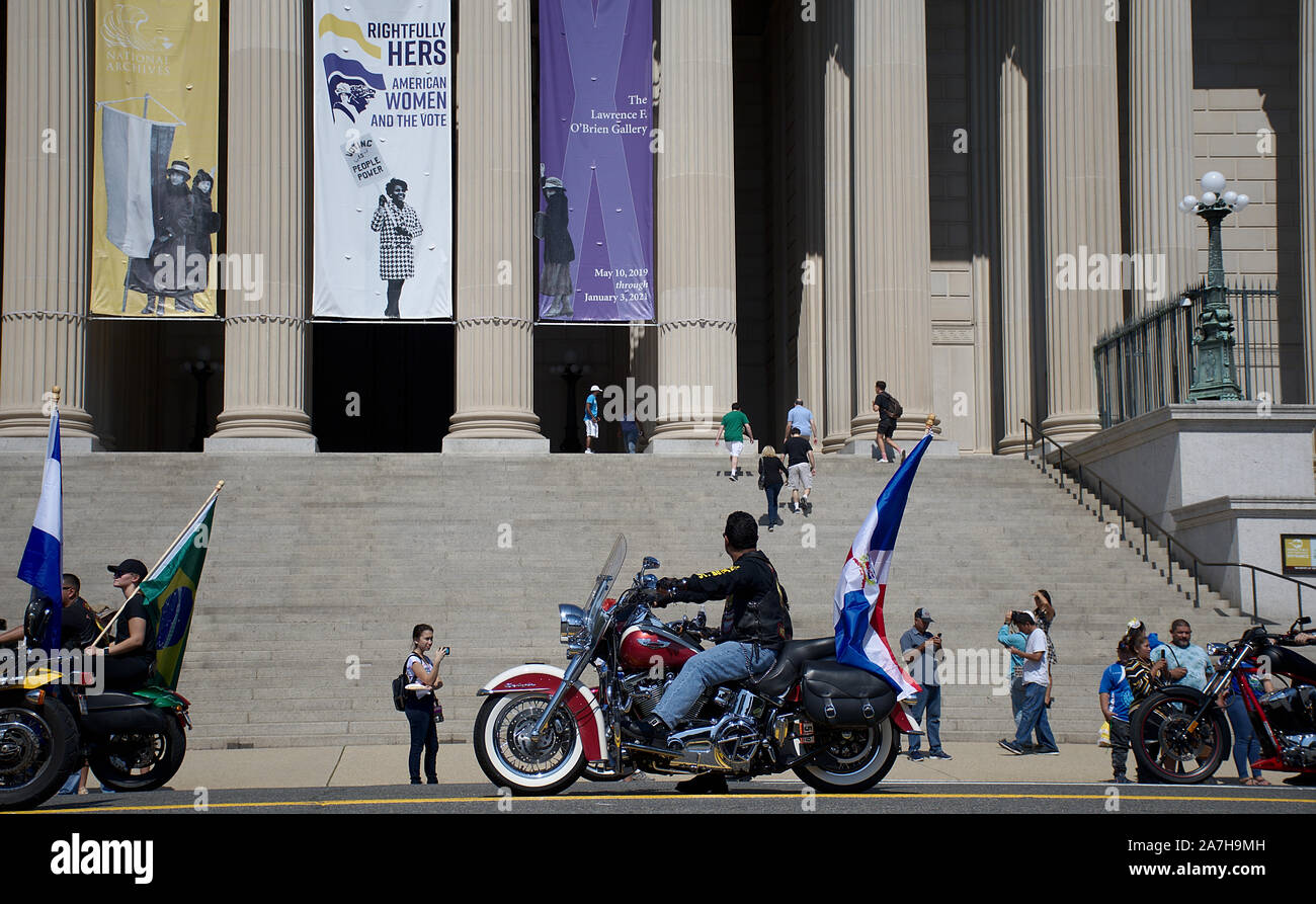 Motorcycle group riding Harley Davidson with South American flags in
