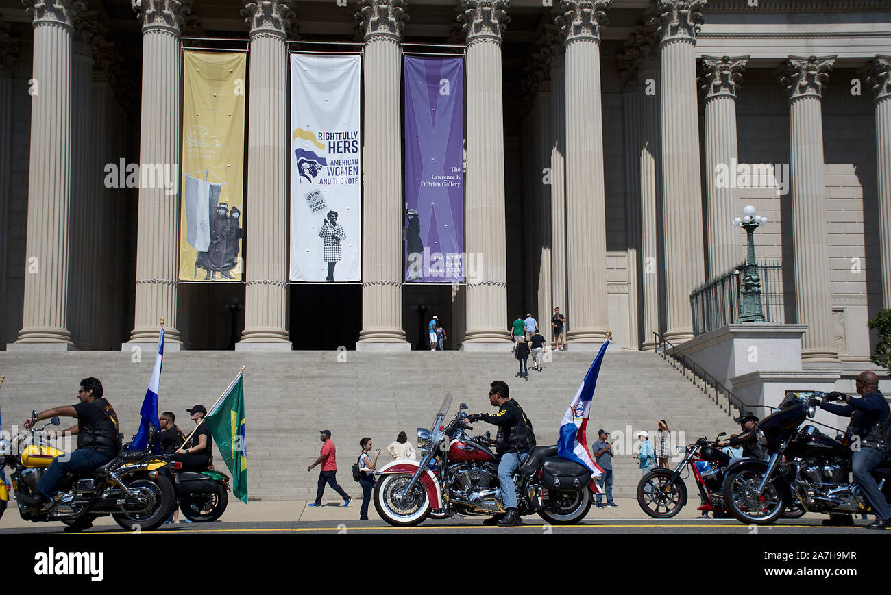 Motorcycle group riding Harley Davidson with South American flags in