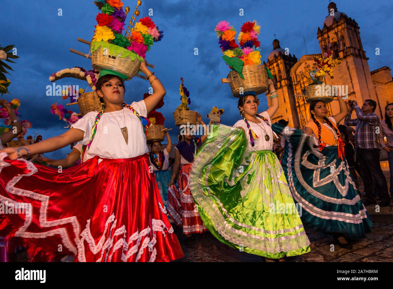 Young women dressed in traditional costumes perform the Flor de Pina ...