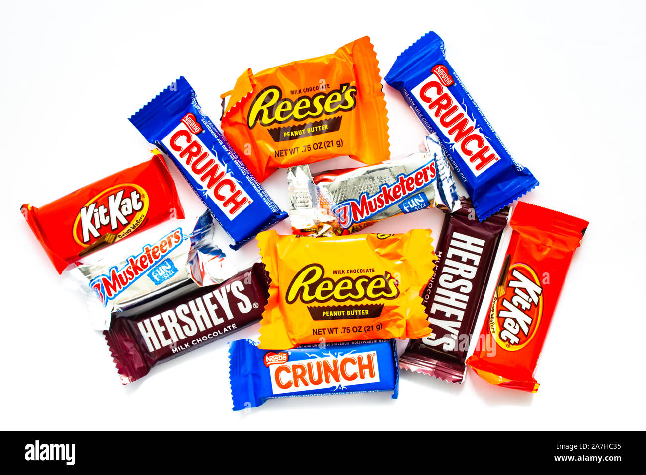 A pile of snack size candy bars for a Halloween Trick or Treat party isolated on white. Stock Photo