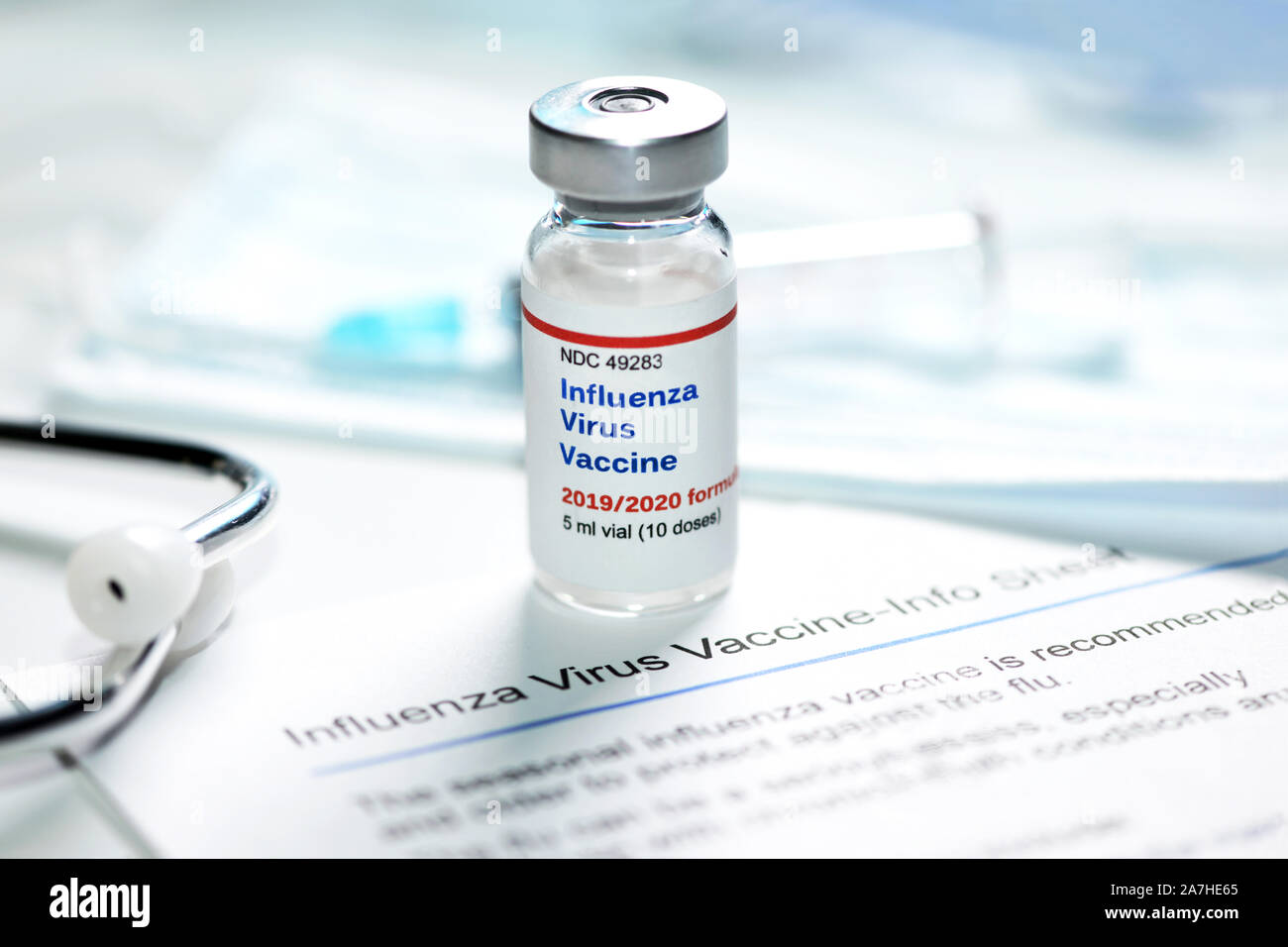 2019-2020 Influenza Virus Vaccine with flu shot information sheet and stethoscope, mask and syringe. Stock Photo