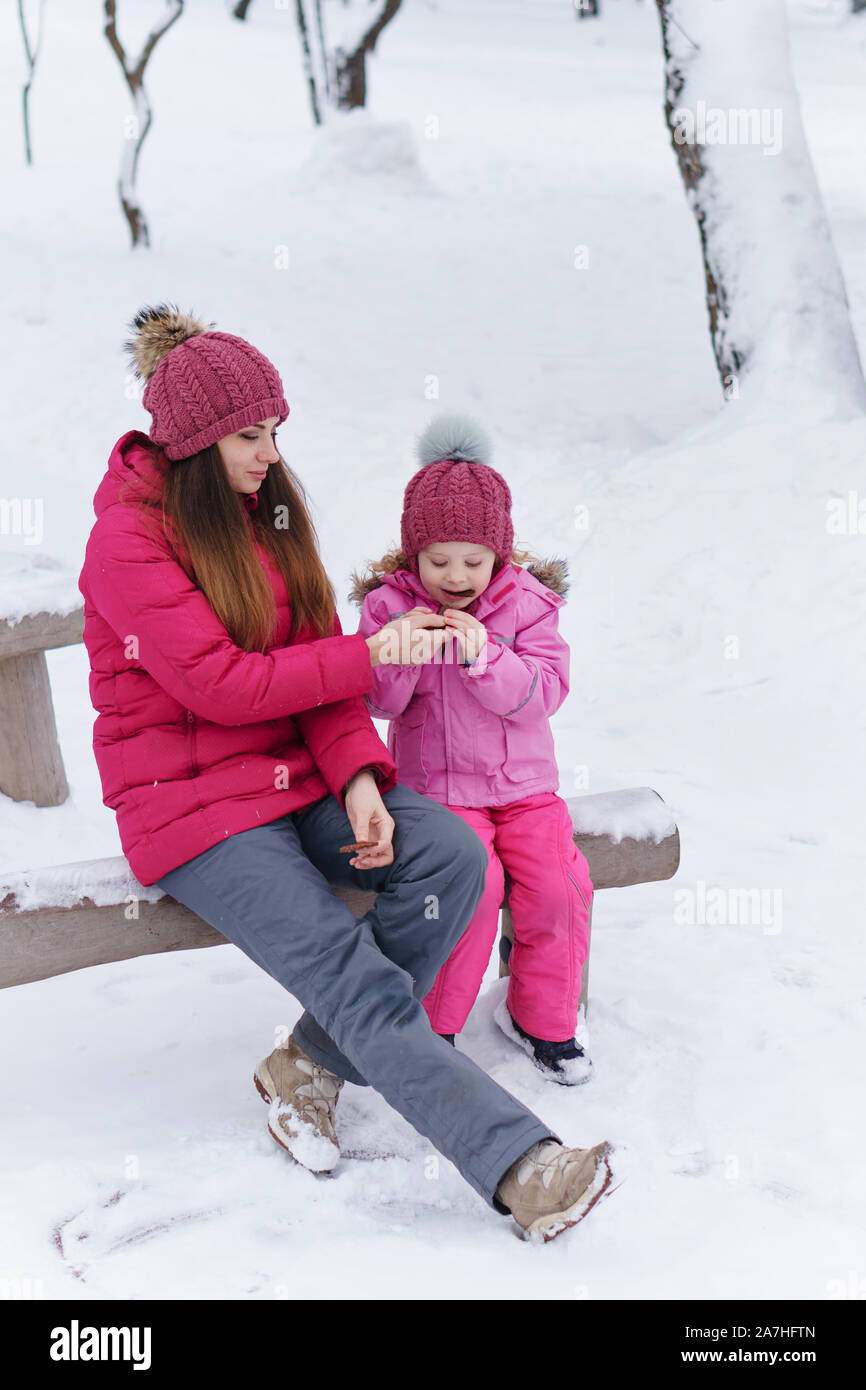 family winter activities on Mom And Daughter At Playground In Winter Relaxation Snack Restore Strength For Outdoor Activities Happiness To Be A Parent Family Look Stock Photo Alamy