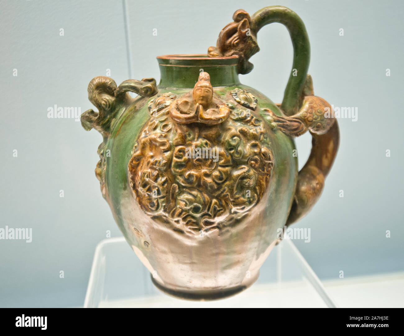 Chinese porcelain: Polychrome glazed pottery pitcher with dragon head and applied design. Tang Dynasty (618-907 A.D.). Shanghai Museum, China. Stock Photo