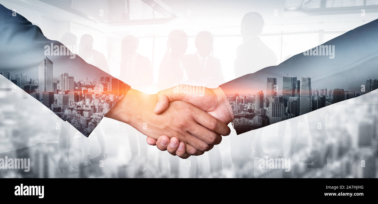 Double exposure image of business people handshake on city office ...