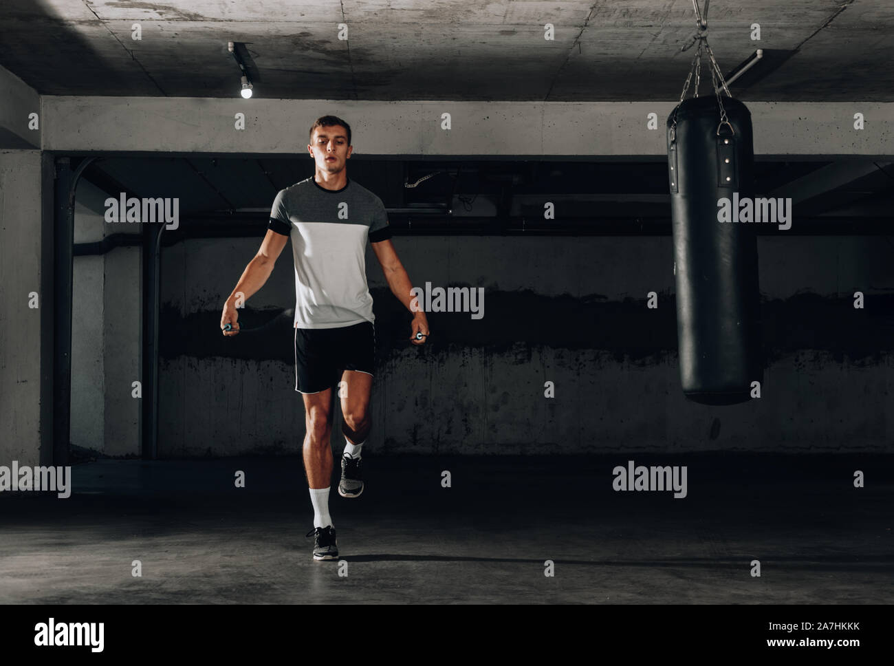 Muscle man skipping rope. Athlete using jump ropes for the workout in a