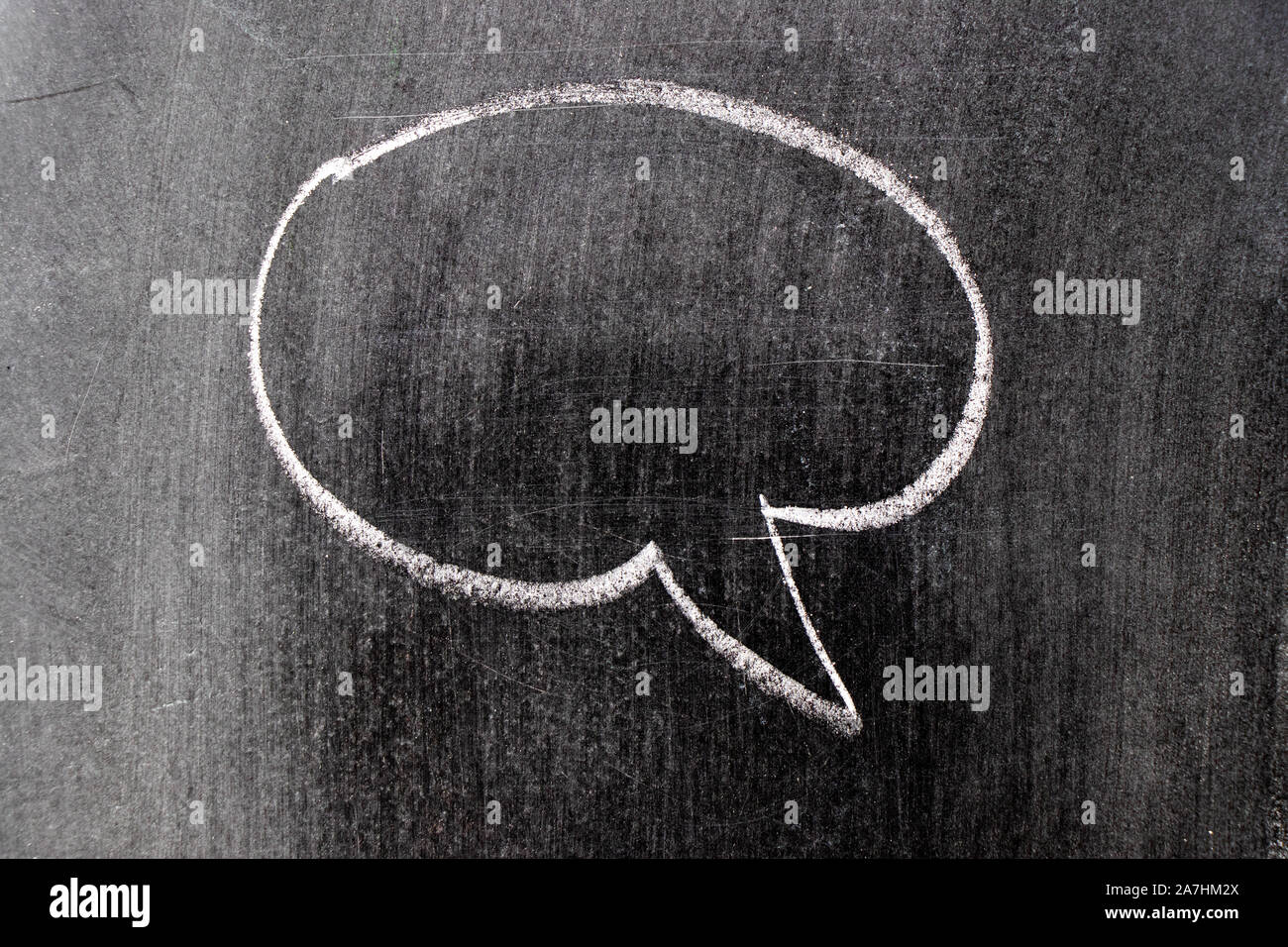 White chalk hand drawing in round bubble speech shape with blank space ...