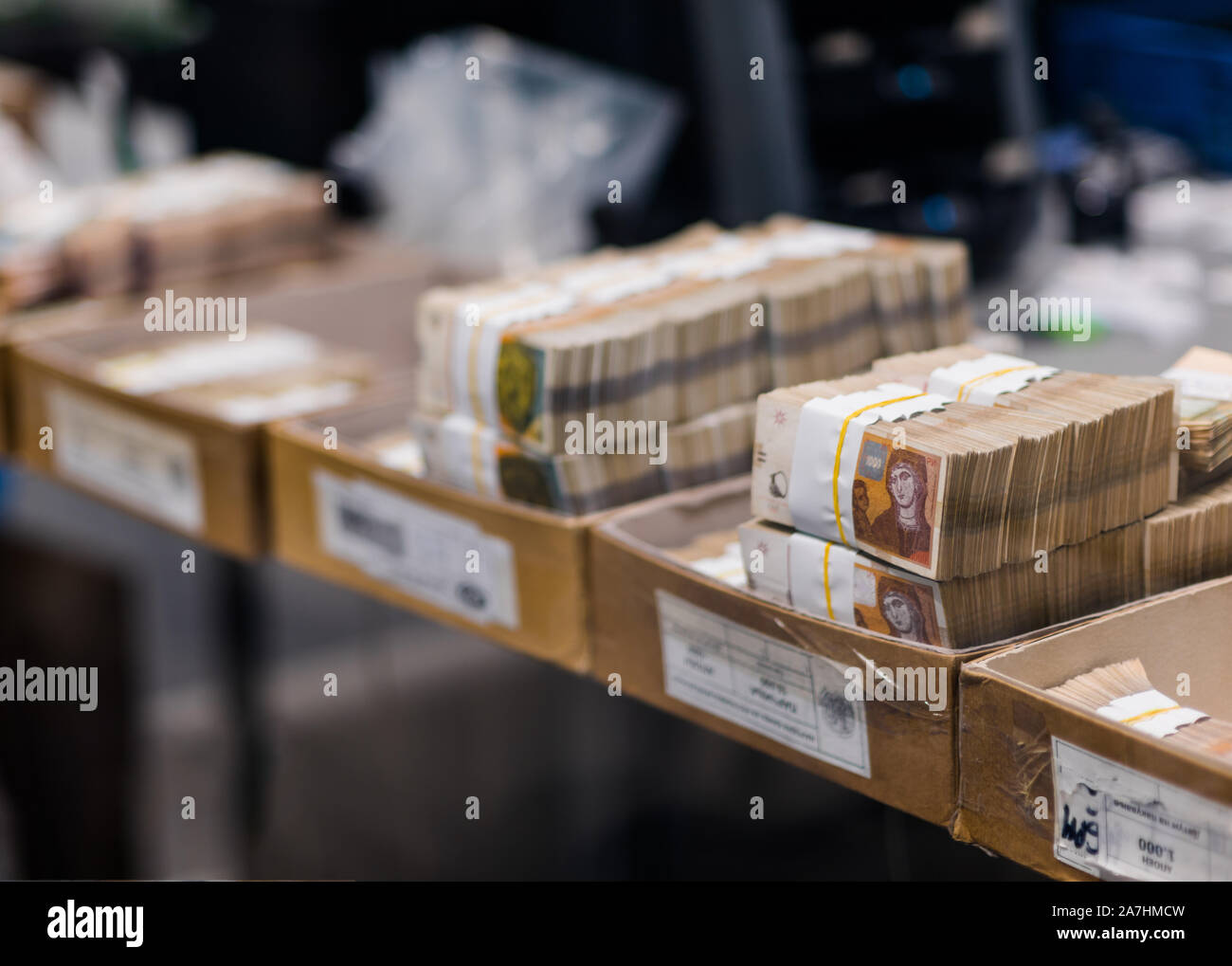 Banknotes strapped with bill bands arranged by number in carton boxes ...