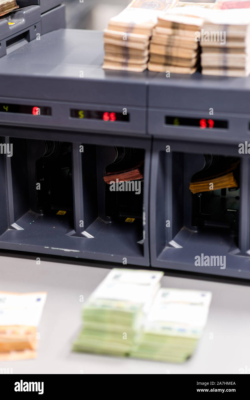 Various types of banknotes being counted simultaneously by a large ...