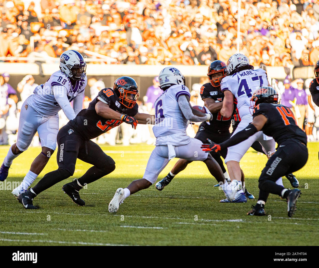 Stillwater, Oklahoma, USA. 2nd Nov, 2019. TCU Horned Frogs running back Darius Anderson (6) looking to split the Cowboys defense as Oklahoma State's linebacker Philip Redwine-Bryant (38) and cornerback Bryce Balous (14) look to stop the run during the game on Saturday, November 02, 2019 at Boone Pickens Stadium in Stillwater, Oklahoma. Credit: Nicholas Rutledge/ZUMA Wire/Alamy Live News Stock Photo