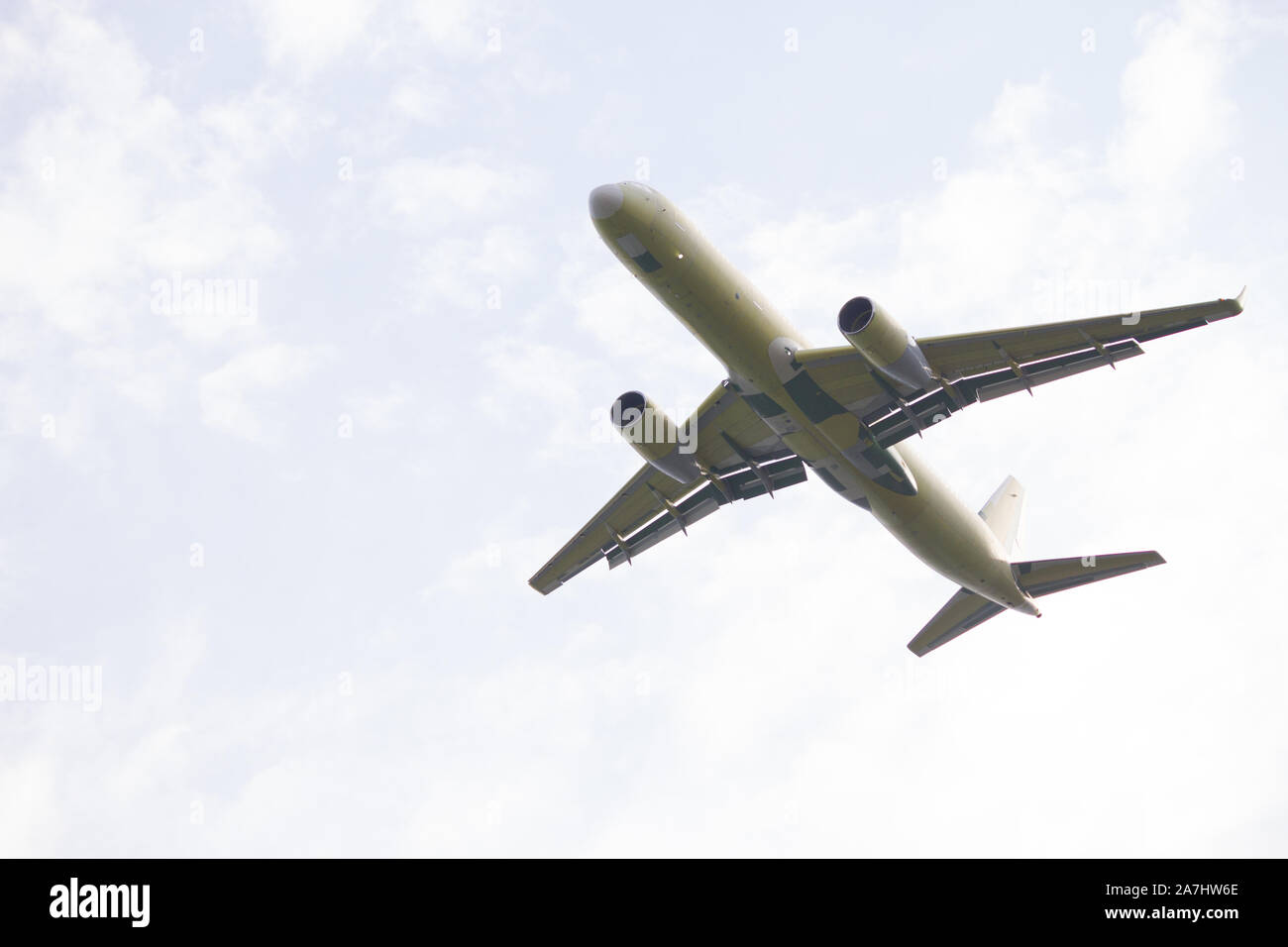 Airplane is flying in the blue sky Stock Photo - Alamy