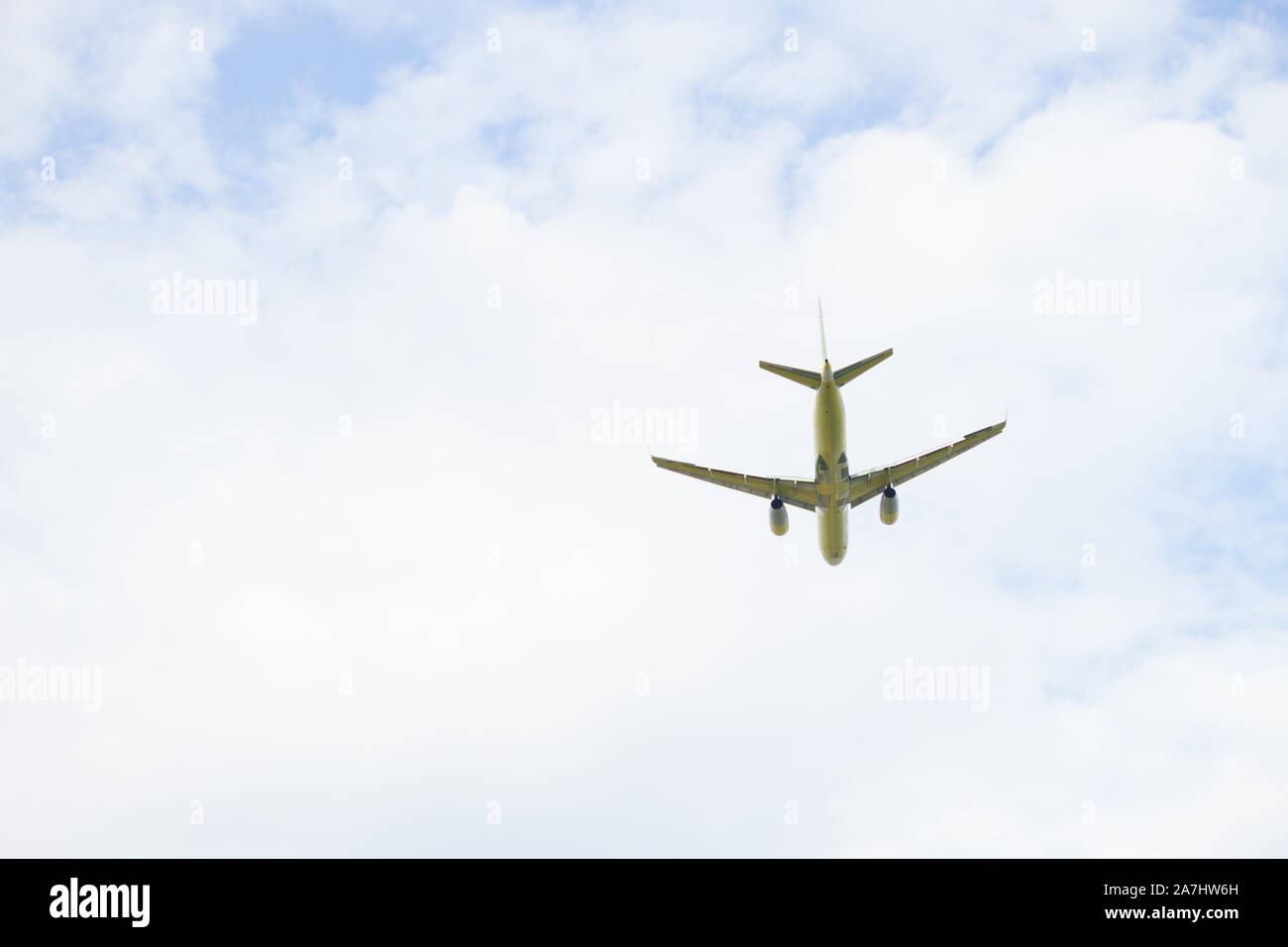 Airplane is flying in the blue sky Stock Photo - Alamy