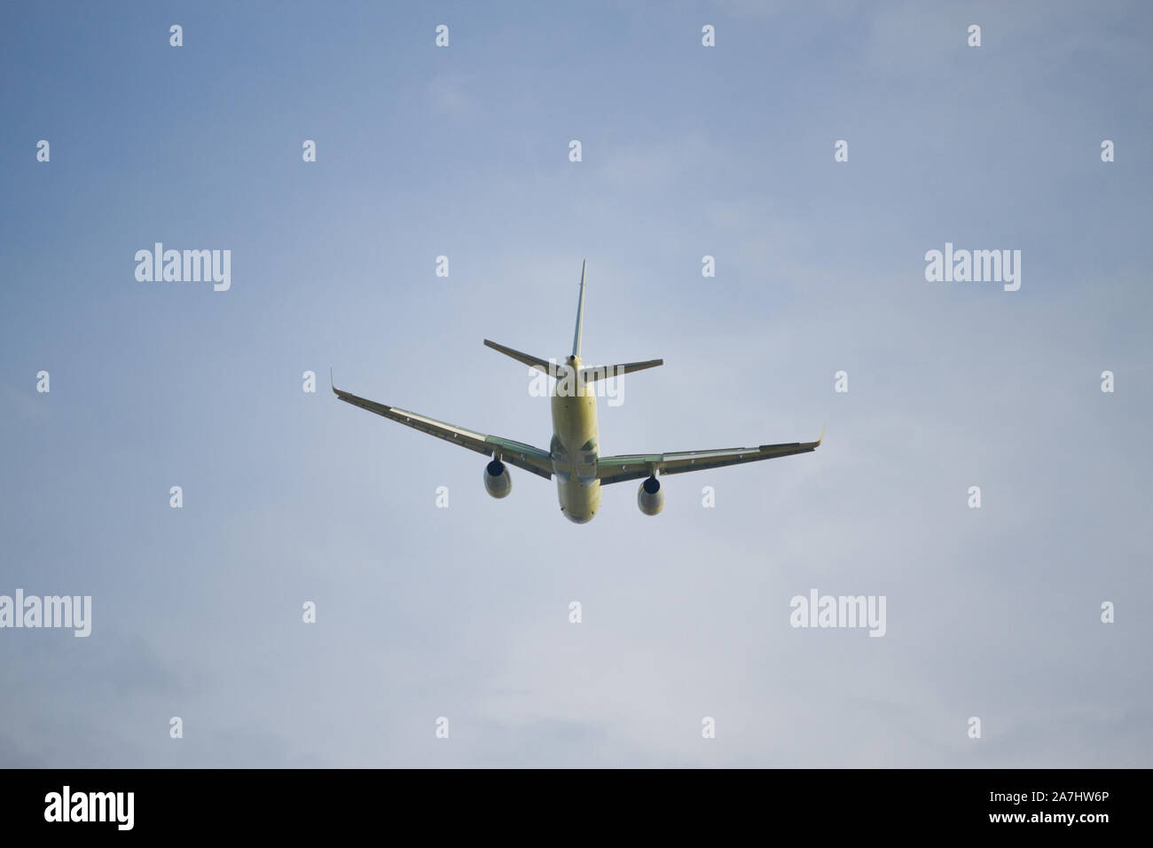 Airplane is flying in the blue sky Stock Photo - Alamy