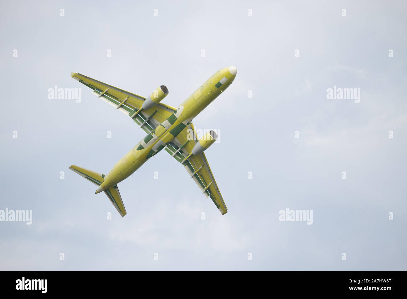 Airplane is flying in the blue sky Stock Photo - Alamy