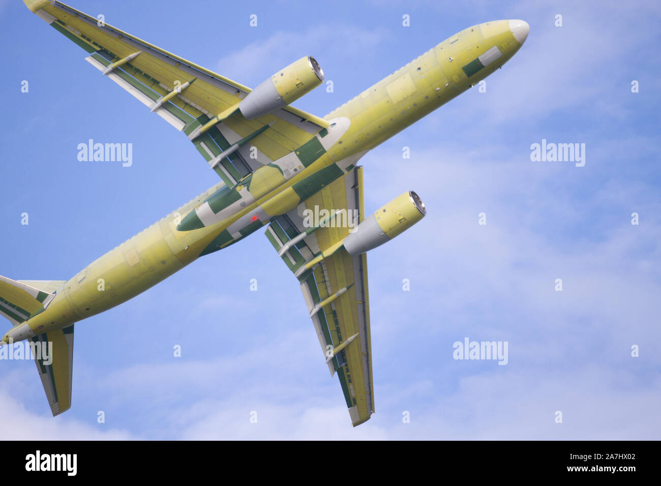Airplane is flying in the blue sky Stock Photo - Alamy